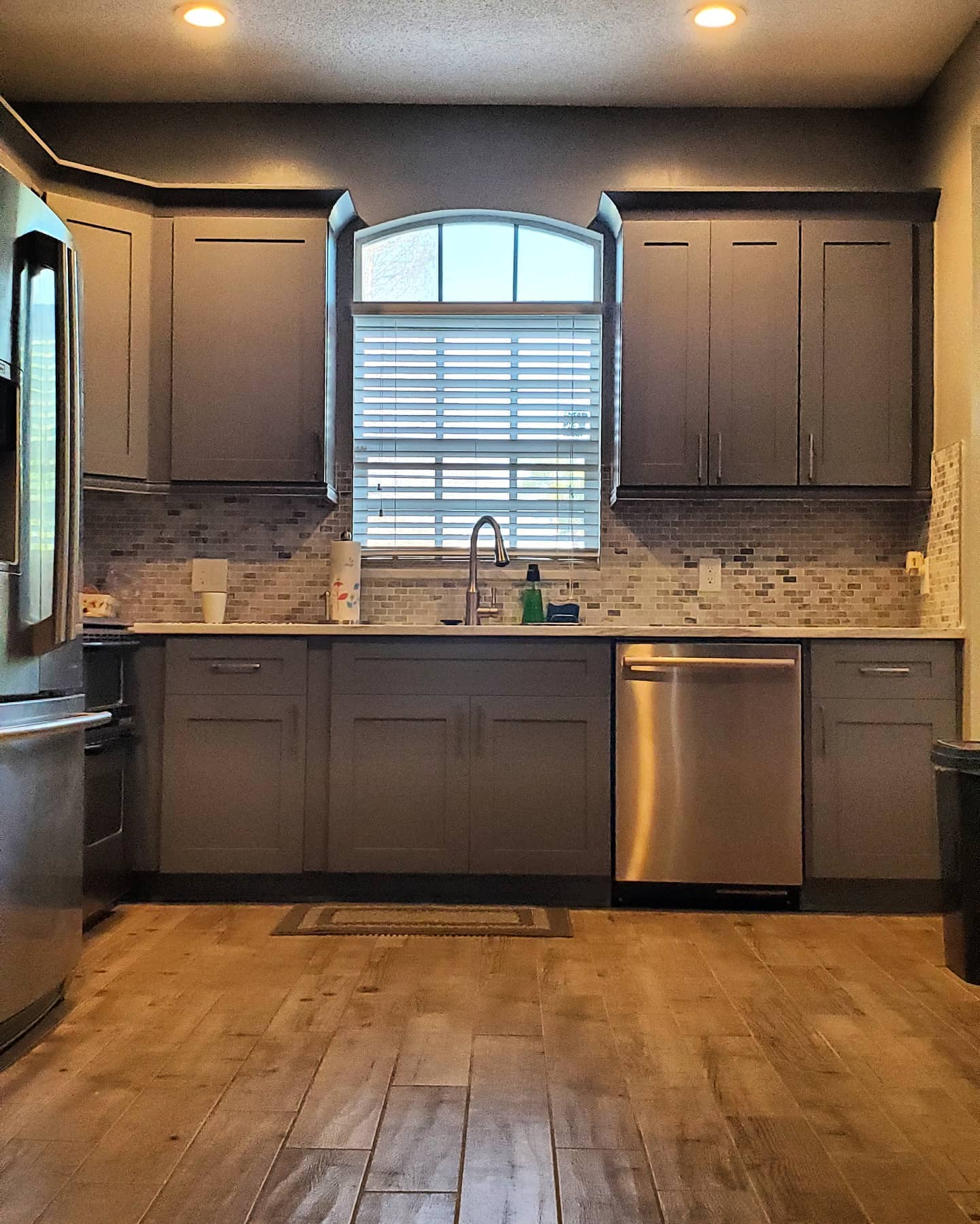 Finished kitchen with gray shaker cabinets and marble counters — Tampa