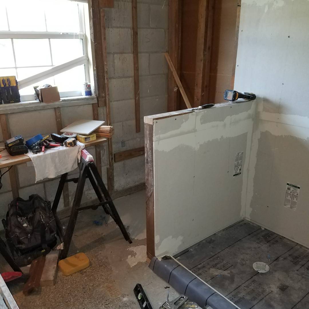 Tub-to-standup-shower conversion with waterproofed walls